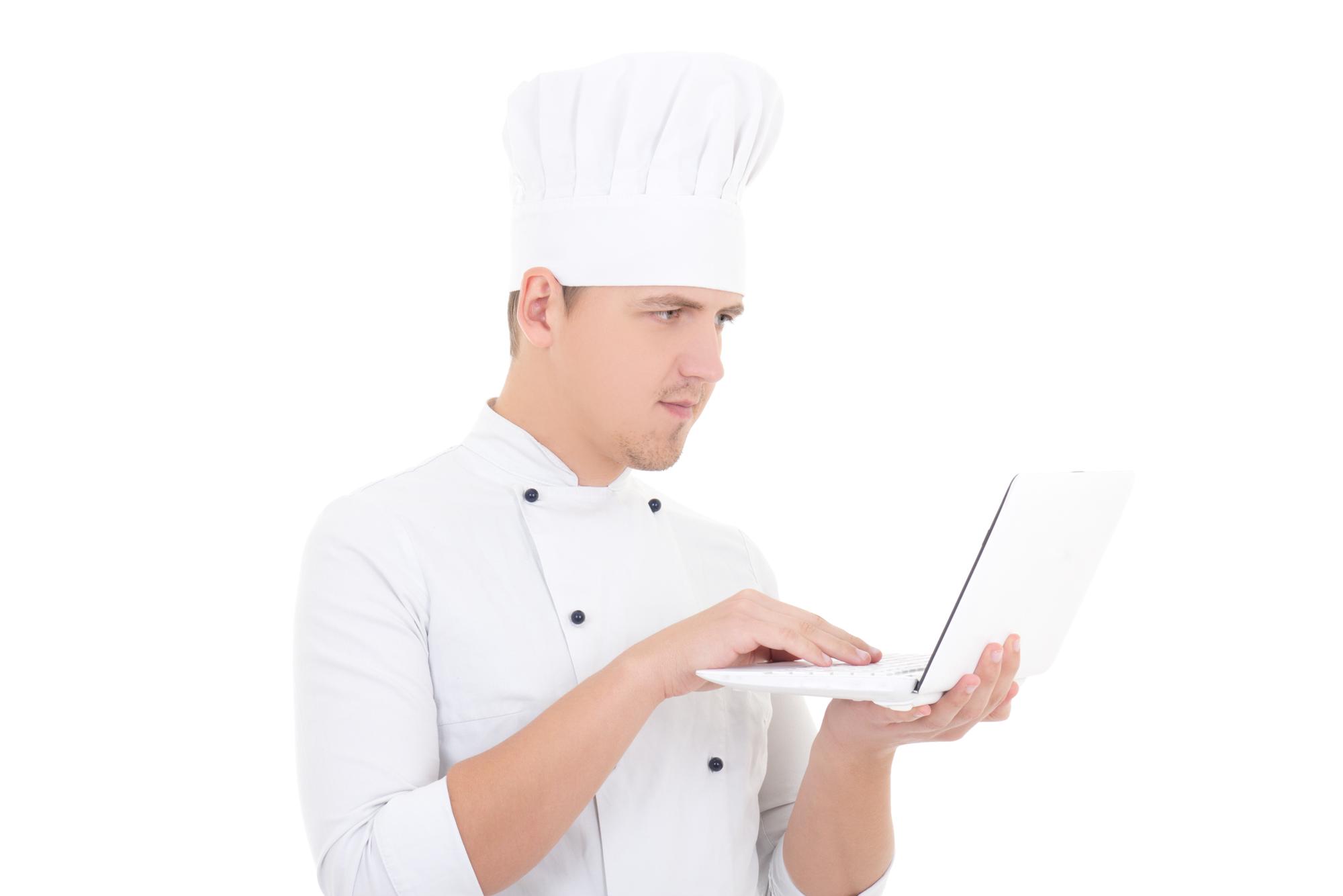 Consultation in a bright kitchen with chef and laptop
